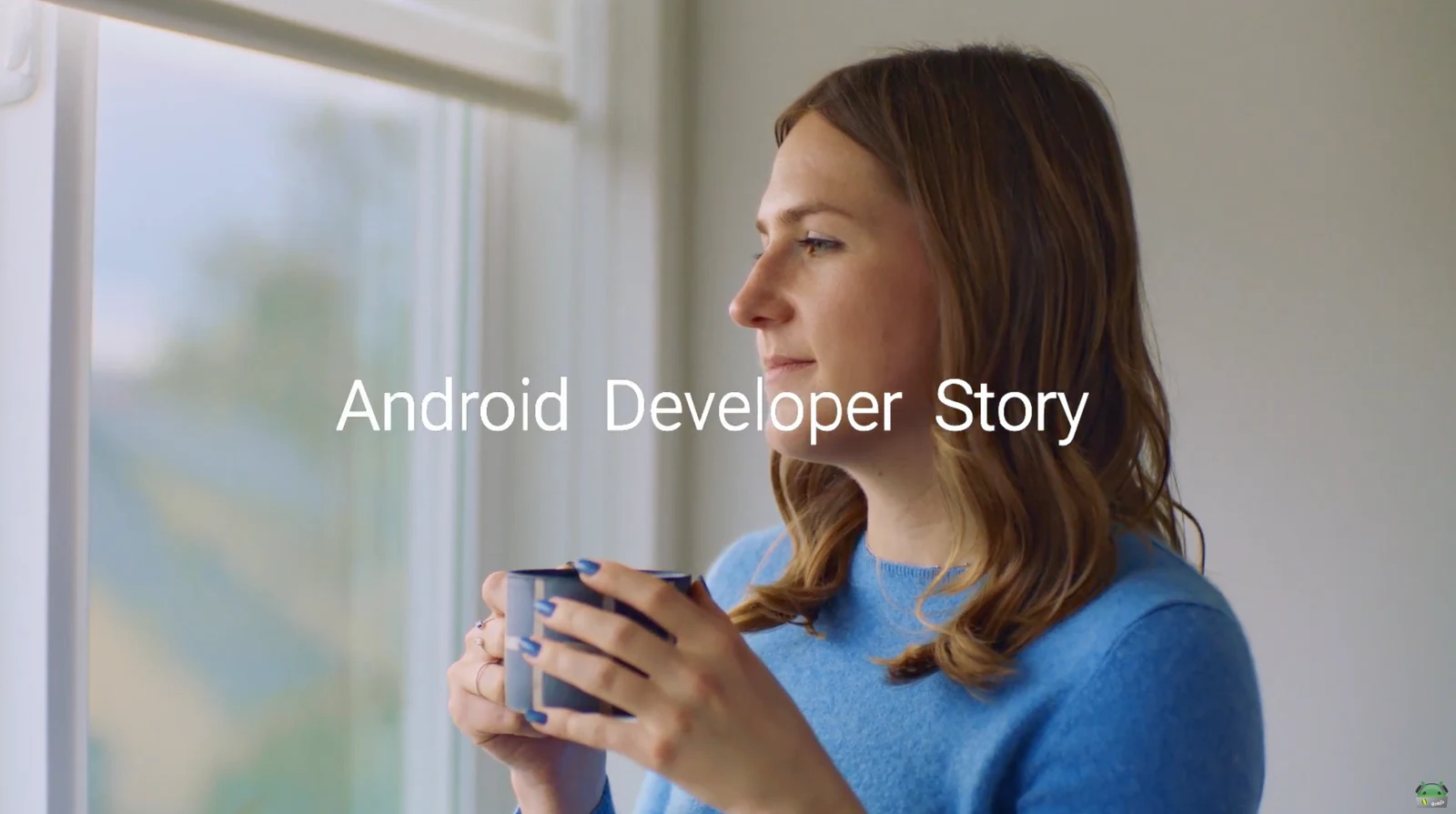 Android Developer Story title over a woman holding a mug beside a window