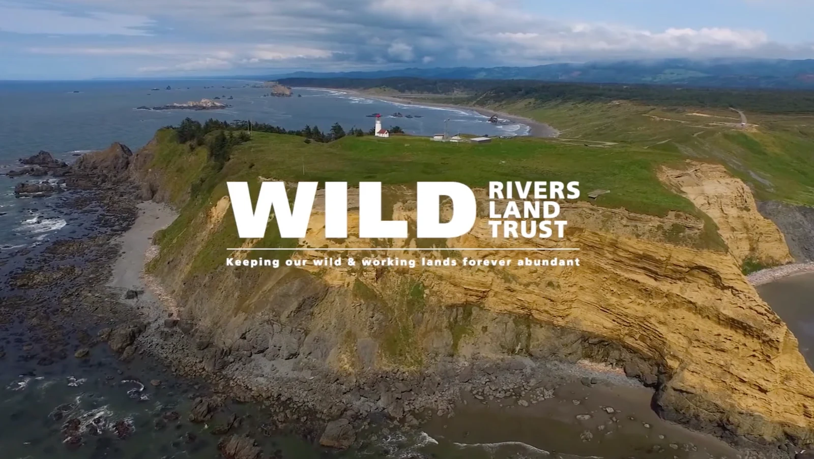 A coastal headland and lighthouse with the Wild Rivers Land Trust title